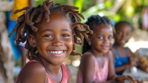 A group of smiling black Caribbean children playing together. Melanin Babies Blog post